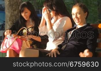 Female friends taking a break on bench in the park