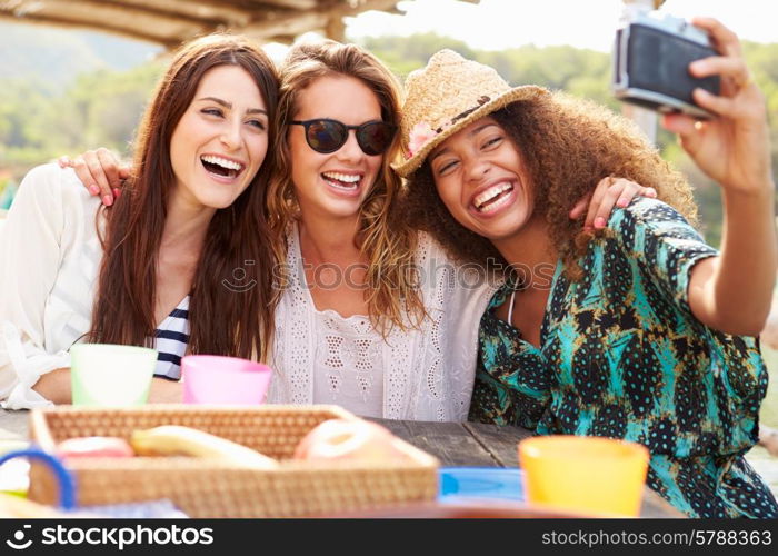 Female Friends Taking Selfie During Lunch Outdoors