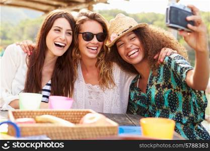 Female Friends Taking Selfie During Lunch Outdoors