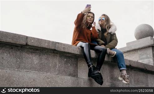 female friends taking selfie outdoors