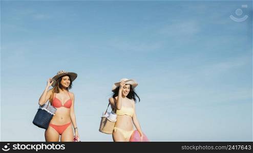 female friends walking shoreline