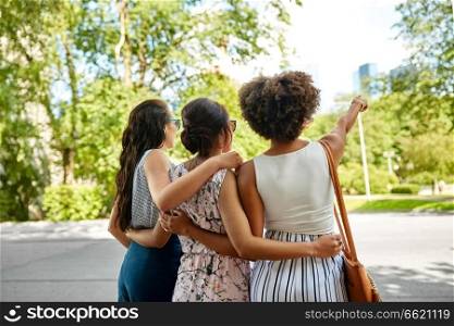 female friendship, people and leisure - young women or friends hugging at summer park. young women or friends hugging at summer park
