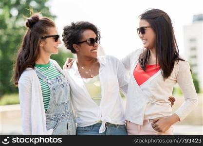 female friendship, summer and eyewear - happy young women in sunglasses outdoors. happy young women in sunglasses outdoors