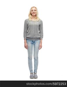 female, gender, fashion and people concept - smiling young woman or teenage girl in gray pullover and jeans