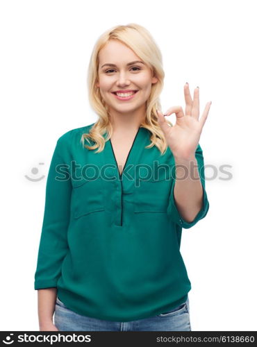 female, gender, gesture, plus size and people concept - smiling young woman in shirt and jeans showing ok hand sign