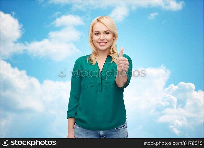 female, gender, gesture, plus size and people concept - smiling young woman in shirt and jeans showing thumbs up over blue sky and clouds background