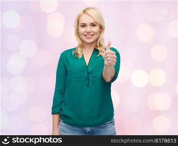 female, gender, gesture, plus size and people concept - smiling young woman in shirt and jeans showing thumbs up over pink holidays lights background