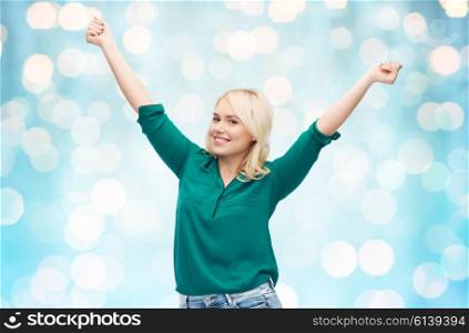 female, gender, joy, plus size and people concept - happy young woman in shirt and jeans over blue holidays lights background