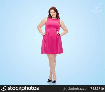 female, gender, portrait and people concept - smiling happy young plus size woman posing in pink dress over blue background