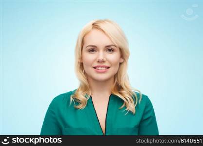 female, gender, portrait and people concept - smiling young woman face over blue background