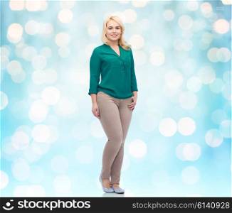 female, gender, portrait, plus size and people concept - smiling young woman in shirt and trousers over blue holidays lights background