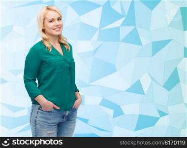 female, gender, portrait, plus size and people concept - smiling young woman in shirt and jeans over blue low poly background