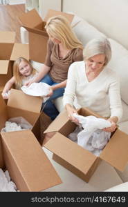 Female Generations of Family Unpacking Boxes Moving House