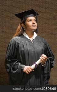 Female graduate holding a diploma