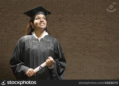 Female graduate holding a diploma