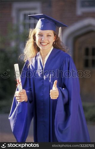 Female Graduate Holding Diploma And Giving Thumbs Up