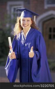 Female Graduate Holding Diploma And Giving Thumbs Up