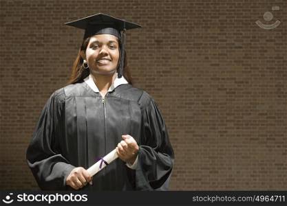 Female graduate holding her diploma