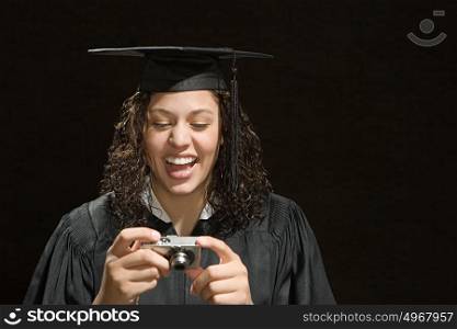 Female graduate looking at photographs