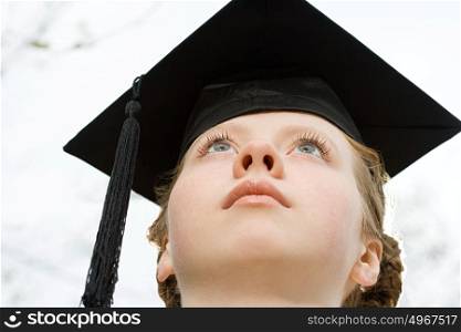 Female graduate looking up