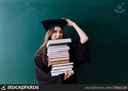 Female graduate student in front of green board 
