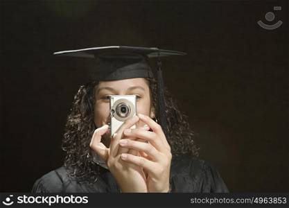 Female graduate taking a photograph