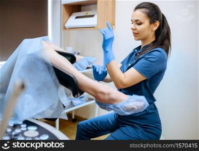 Female gynecologist in gloves and uniform and patient in chair, Gynecological examination in clinic, gynecology diagnostic or consultation, exam. Female gynecologist and patient in chair, exam