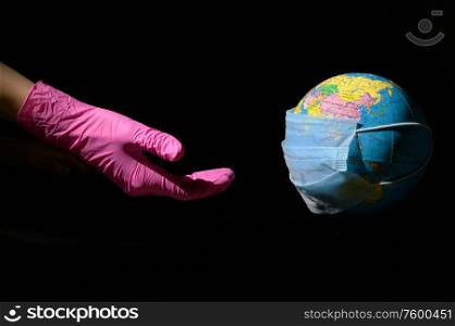 Female Hand And Earth With Mask To Fight Against Virus