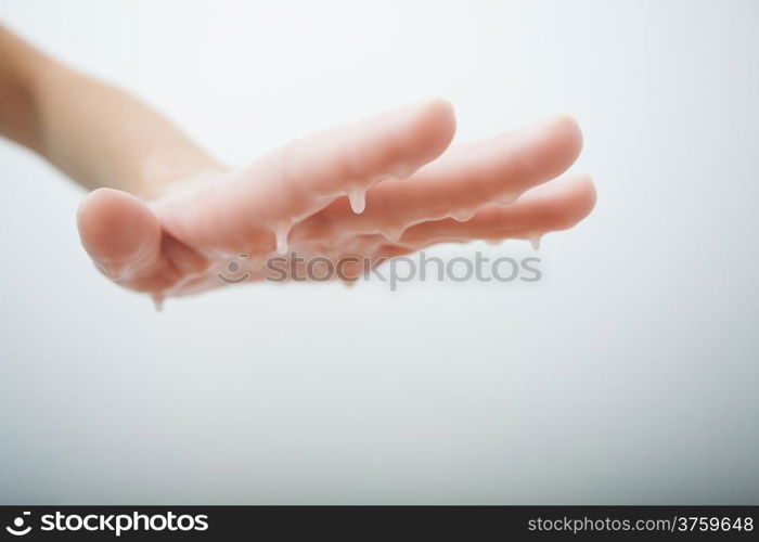 Female hand and parrafin wax bath. Manicure and skincare. Woman in beauty spa salon.