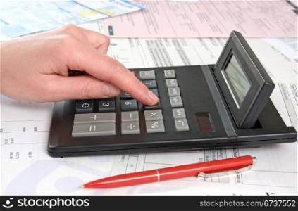 female hand,calculator and financial reports
