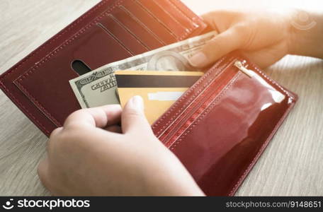 Female hand get money and  credit card from wallet 