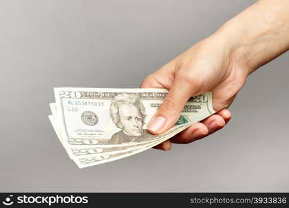 Female hand holding a 20 Dolar, on a dark background