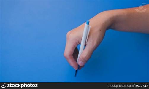 Female hand holding a pen to write Suitable for making infographics.
