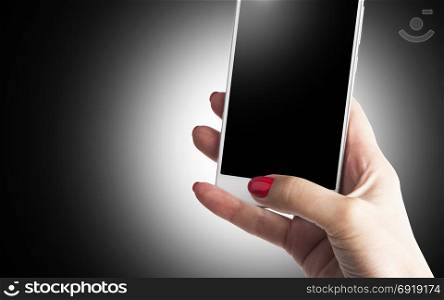 Female Hand holding and Touching a Smartphone isolated on black background
