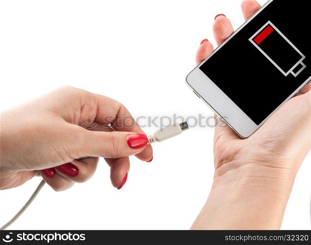 Female hand holding low battery smartphone and connect charger isolated on white background