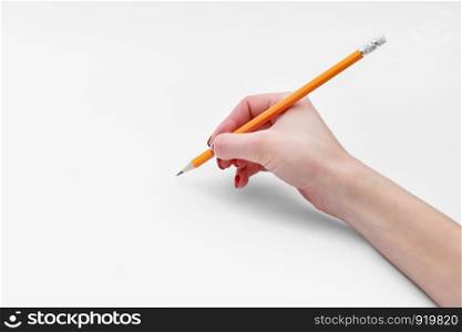Female hand holding pencil isolated on white background, close-up, cutout. Female hand holding pencil isolated on white background, close-up, cutout, copy space