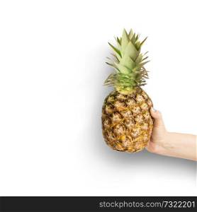 Female hand holding pineapple at white background. Summer tropical fruits concept. Isolated. Copy space for your design