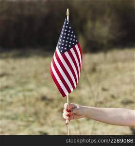 female hand holding usa flag during independence day