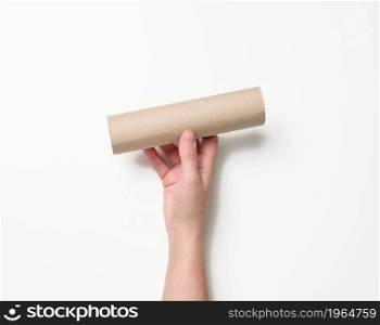 female hand holds a paper tube from under used napkins on a white background. Product has run out