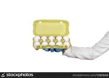 Female hand in disposable glove holds open box of eggs. Hygiene in the kitchen concept. Copy space. Female hand in disposable glove holds open box of eggs. Hygiene in the kitchen concept.