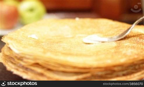 female hand oils pancakes. HD1080.