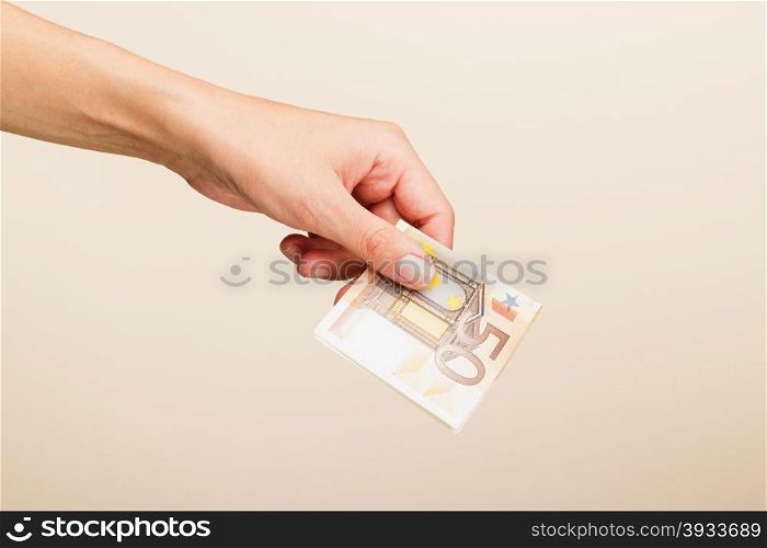 female hand on a light background. female hand holding euro bills