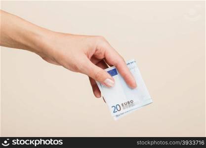 female hand on a light background. female hand holding euro bills