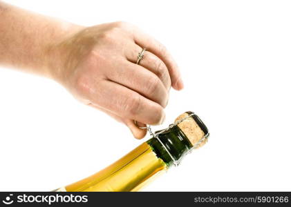 Female hand opening a bottle of champagne a new years eve
