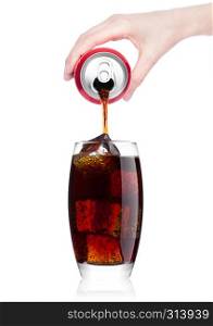 Female hand pouring cola soda drink from aluminium can to glass with ice cubes on white background