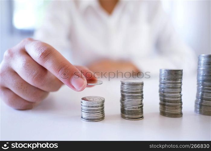 Female hand stack coins growing business. Saving money