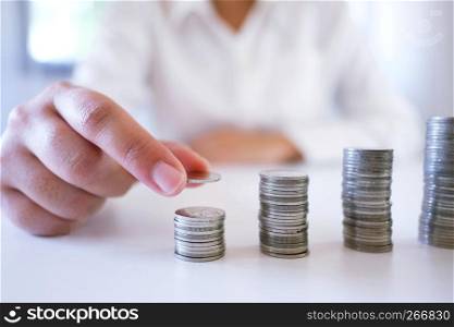 Female hand stack coins growing business. Saving money