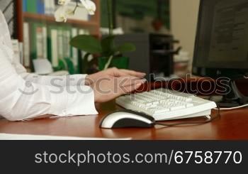 female hand typing on a keyboard in the office