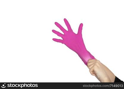 Female hand wears a protective glove for cleaning or tidying. Woman&rsquo;s hand in pink latex glove gesture or sign isolated on white. Female hand putting on latex glove isolated on white background. Female hand wears a protective glove for cleaning or tidying