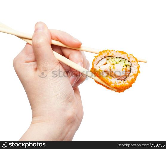 female hand with disposable chopsticks holds california ebi sushi roll isolated on white background